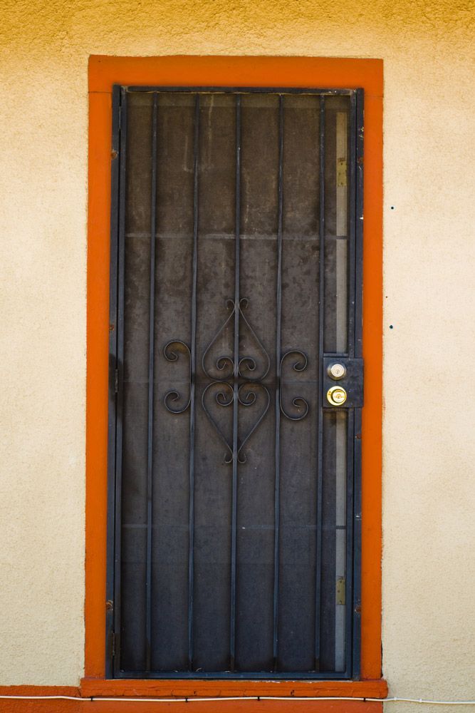 Orange Door Trim And Black Security Door — Wholesale Window Coverings in Newcastle, NSW