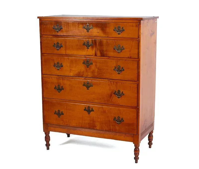 A wooden chest of drawers on a white background