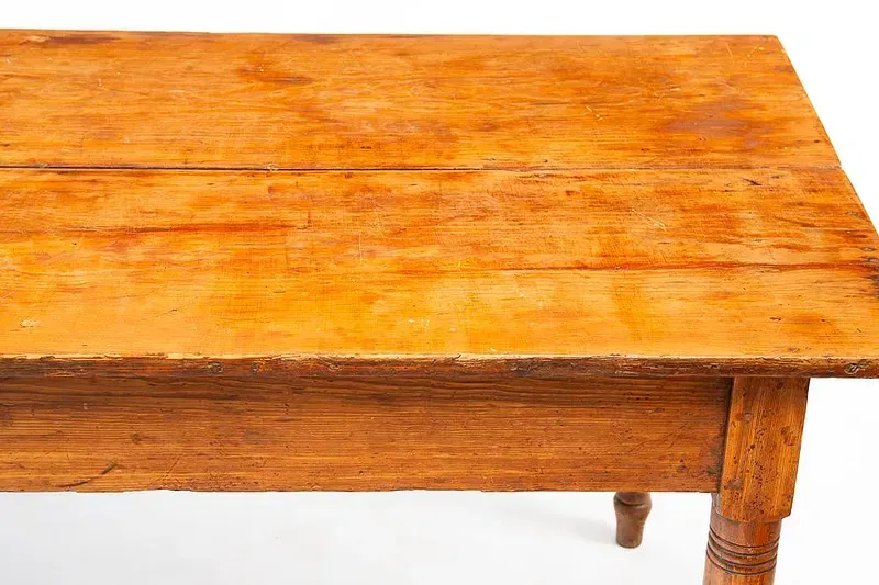 A close up of a wooden table on a white background.