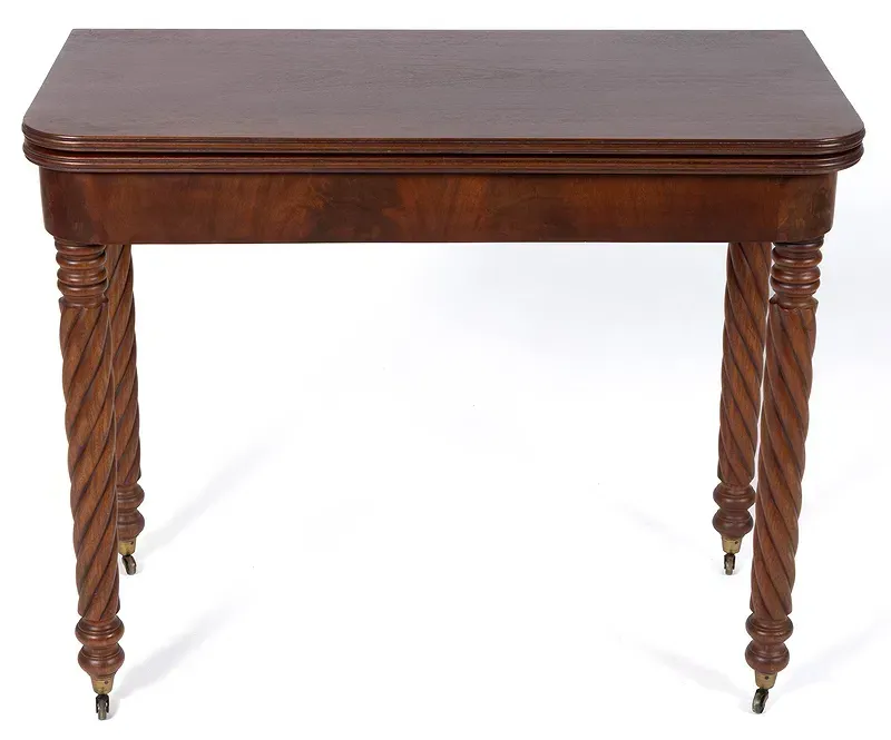 A wooden table with twisted legs on a white background