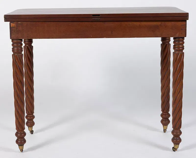 The back of a wooden dresser with a white background