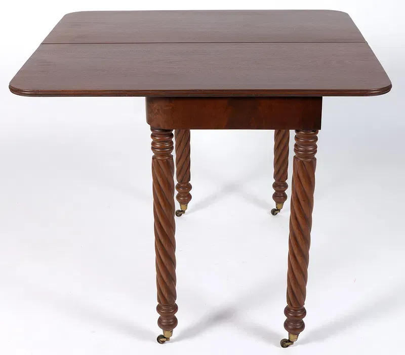 A wooden table with twisted legs on a white background