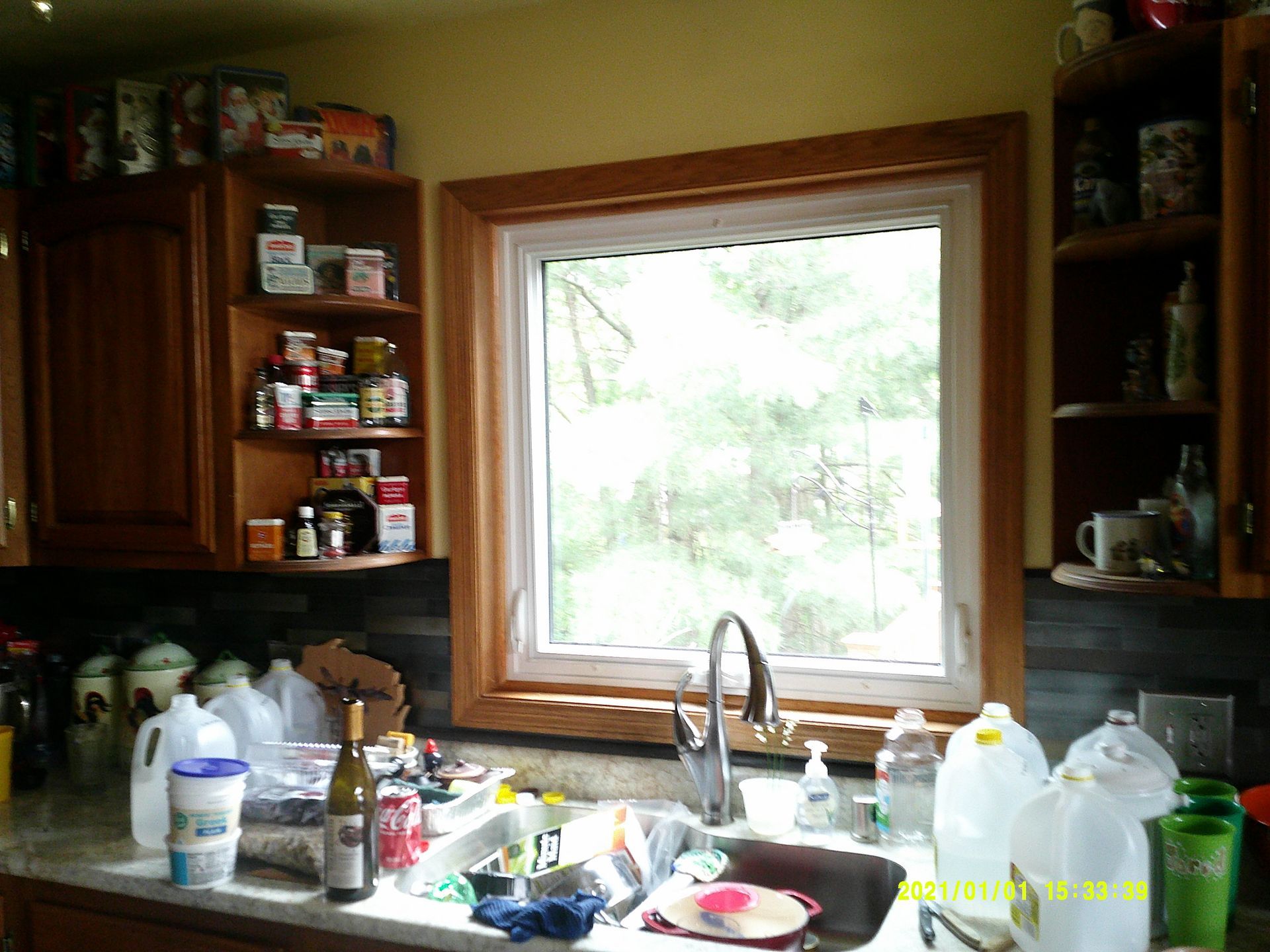 A kitchen with a sink and a large window