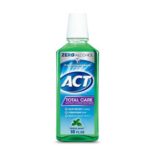 Bottle of ACT Total Care mouthwash, green liquid, white cap, mint flavor.