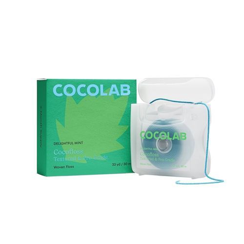 Cocolab dental floss and box in mint green and white. The floss is in a blue plastic container.