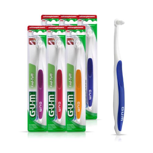 A gum end soft toothbrush with a purple handle