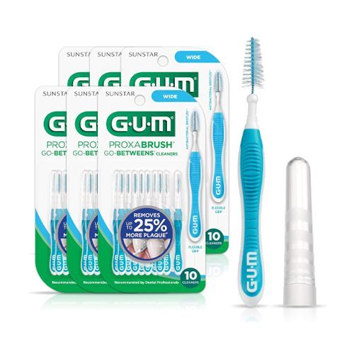 A person is holding a blue toothbrush in their hand