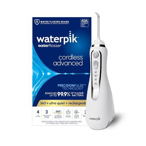 A water flosser is sitting on a white surface.