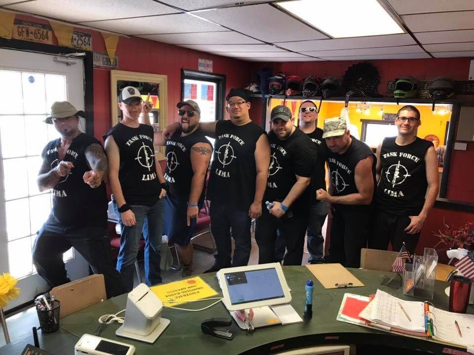 A group of men are posing for a picture in a room.