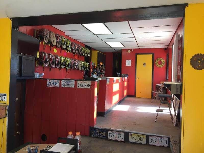 A room with a lot of license plates on the wall