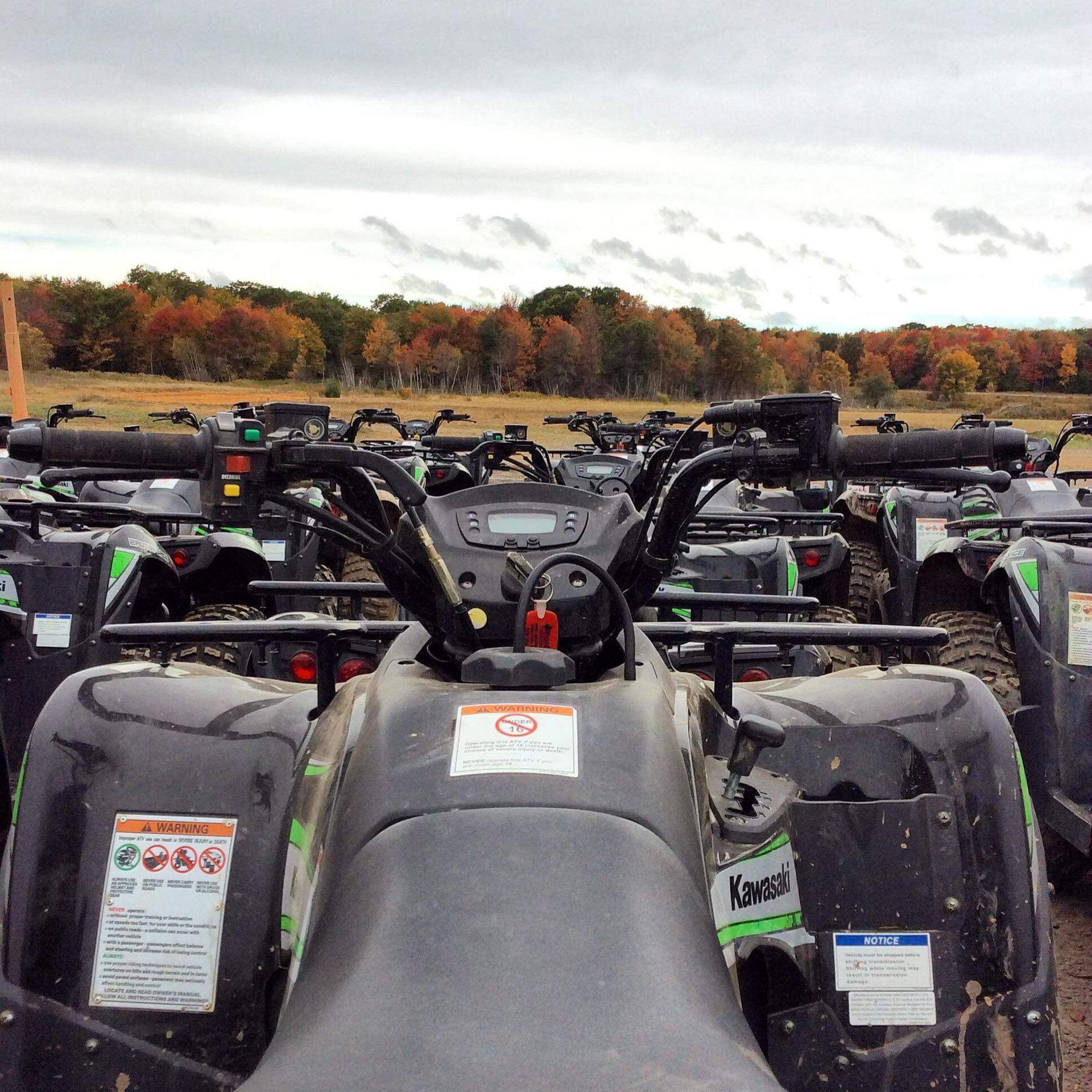 A kawasaki atv is parked in a field