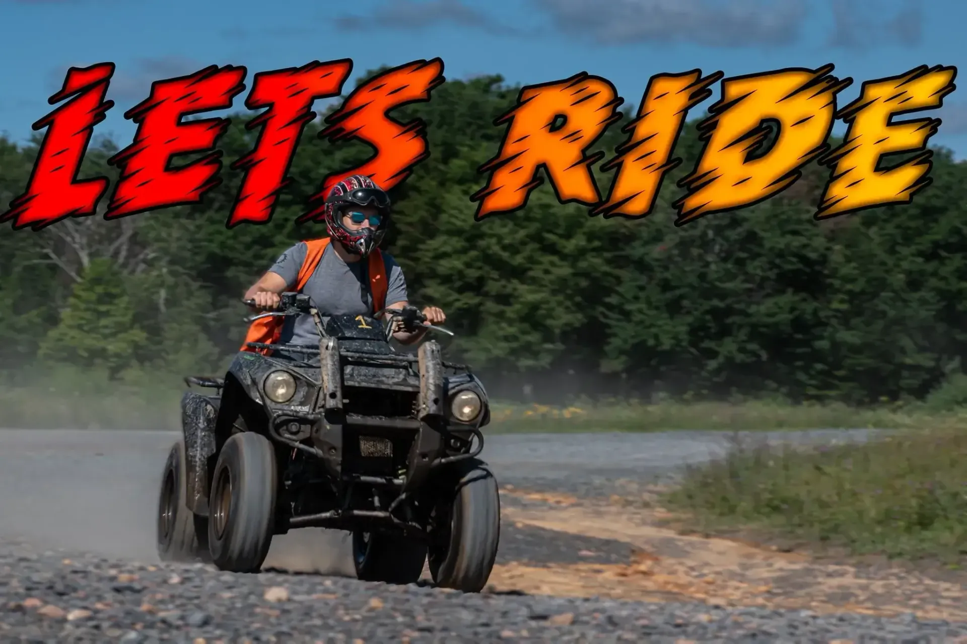 A man is riding an atv on a dirt road with the words let 's ride behind him