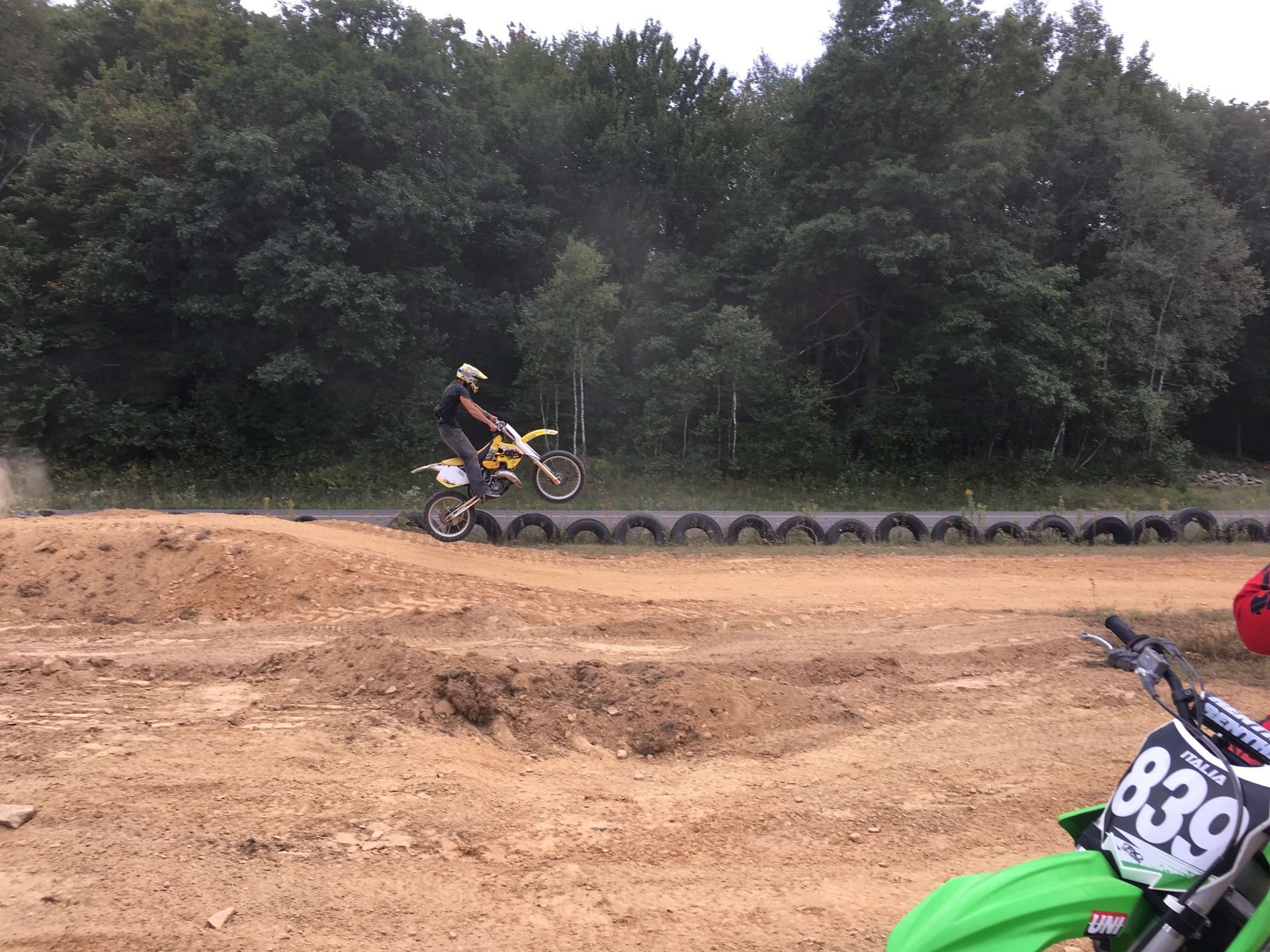 A person is riding a dirt bike on a dirt track.
