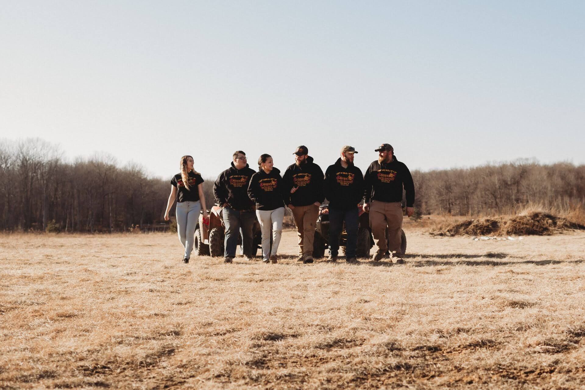 A group of people are walking in a field.