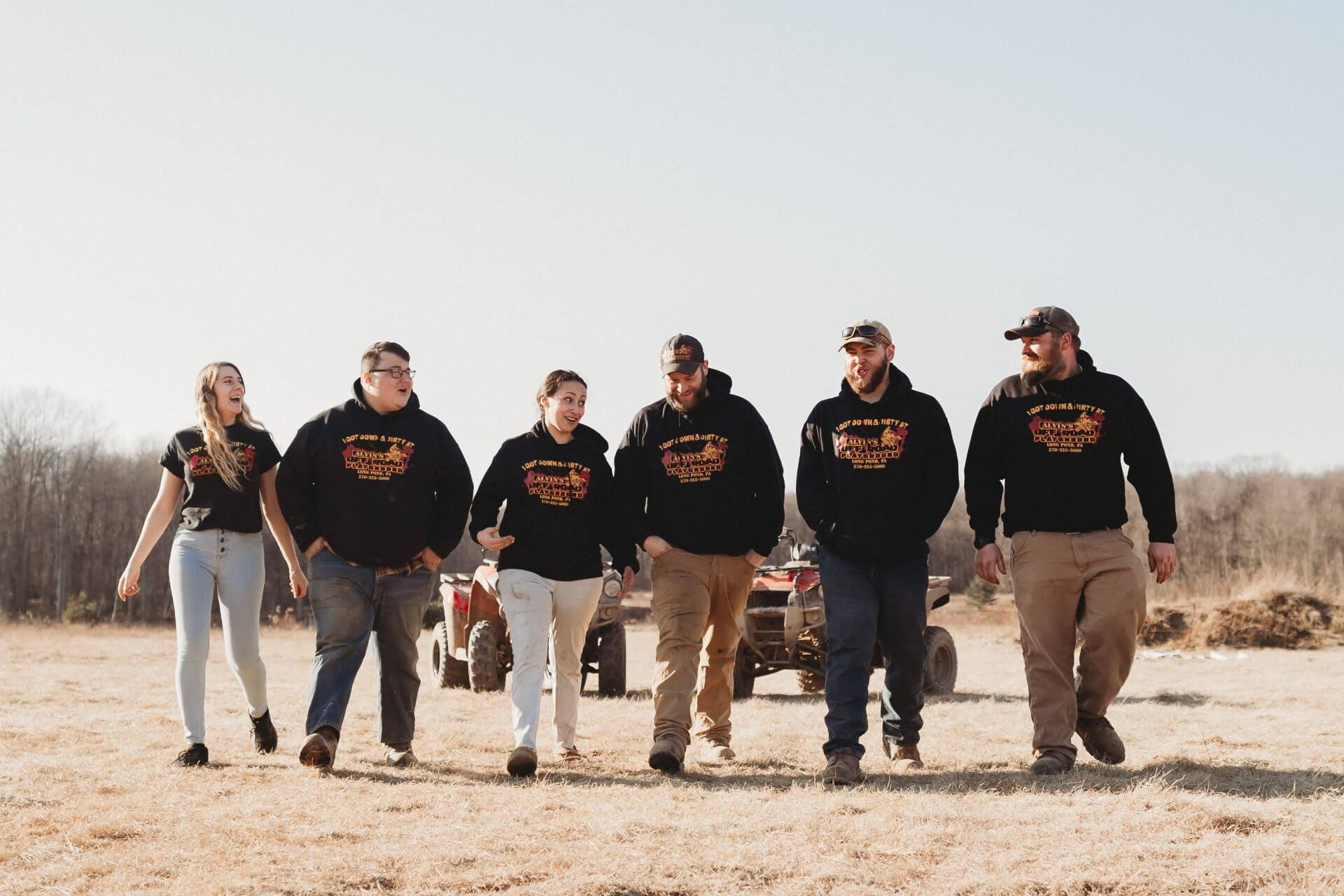A group of people are walking in a line in a field.