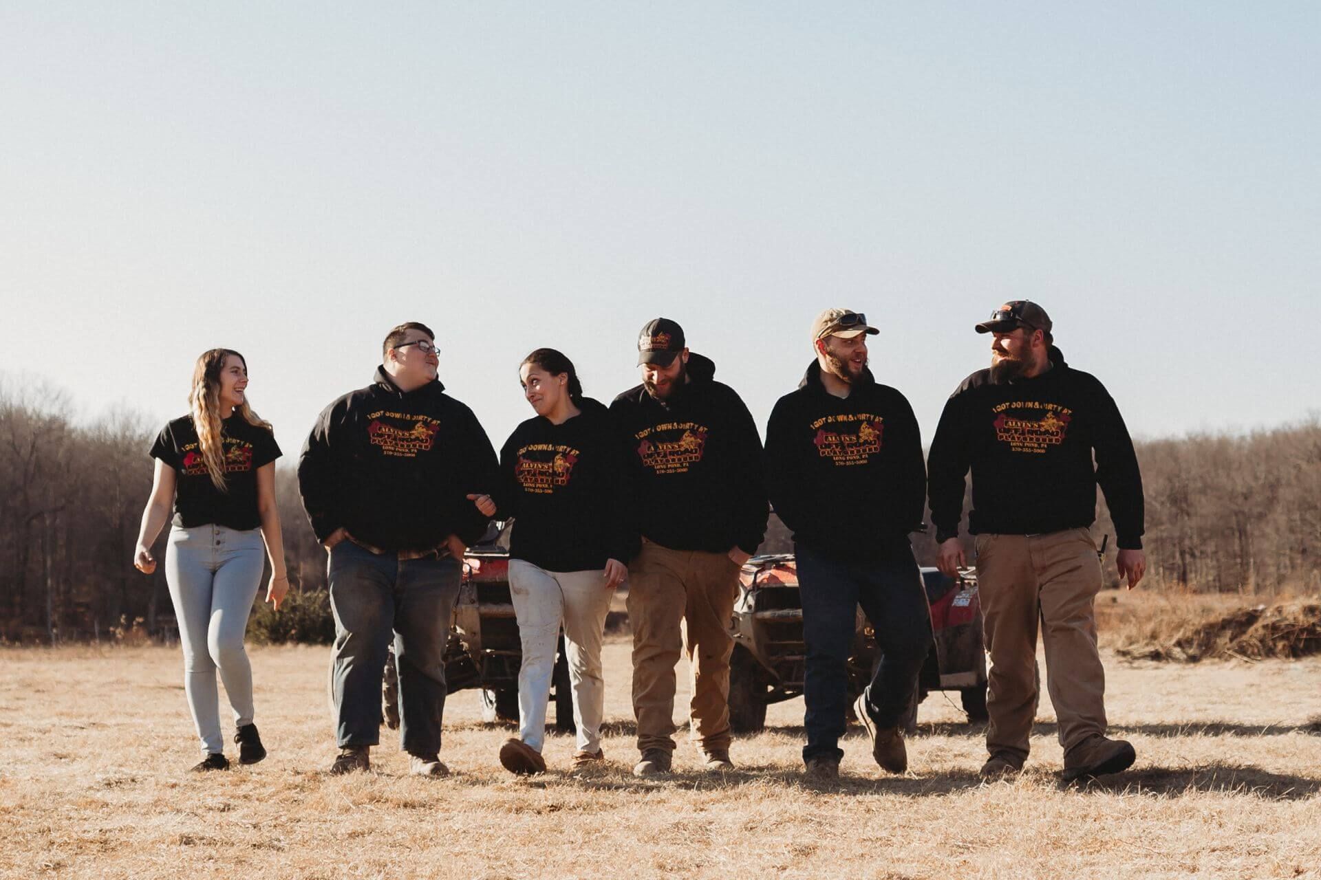 A group of people are walking in a line in a field.