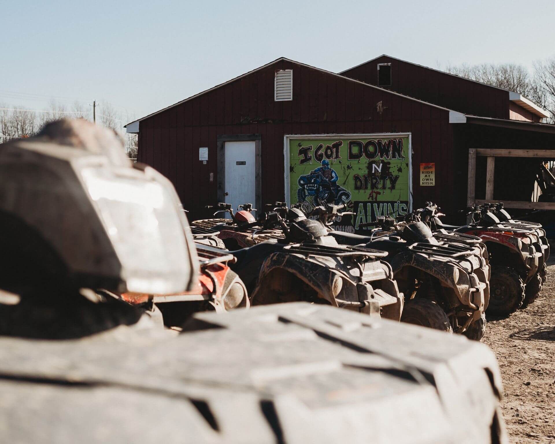 A row of atvs are parked in front of a building.