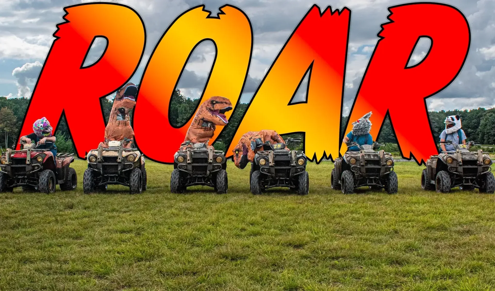 A group of atvs are lined up in a field with the word roar in the background.