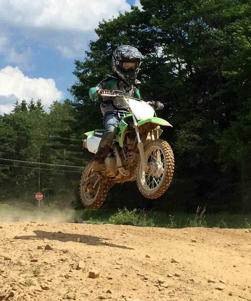 A person on a dirt bike is jumping in the air