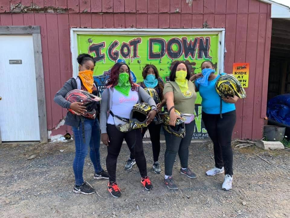 A group of women standing in front of a sign that says `` i got down ''.