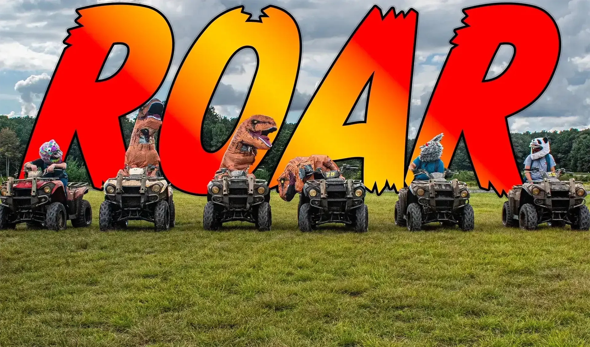 A group of people are riding four wheelers in a field.