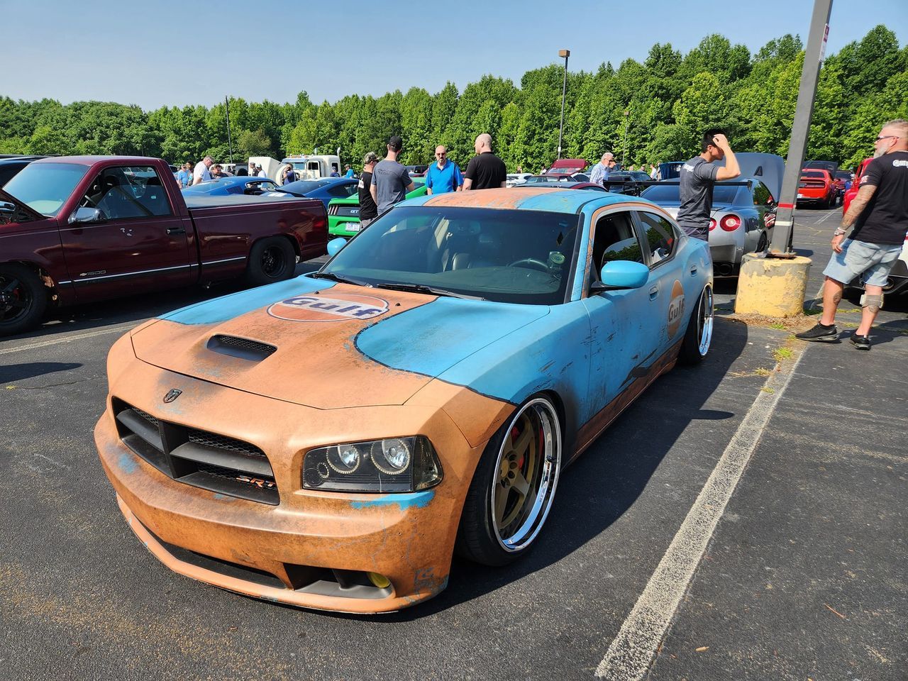 A dodge charger is parked in a parking lot
