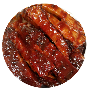 A close up of a plate of barbecue ribs on a white background