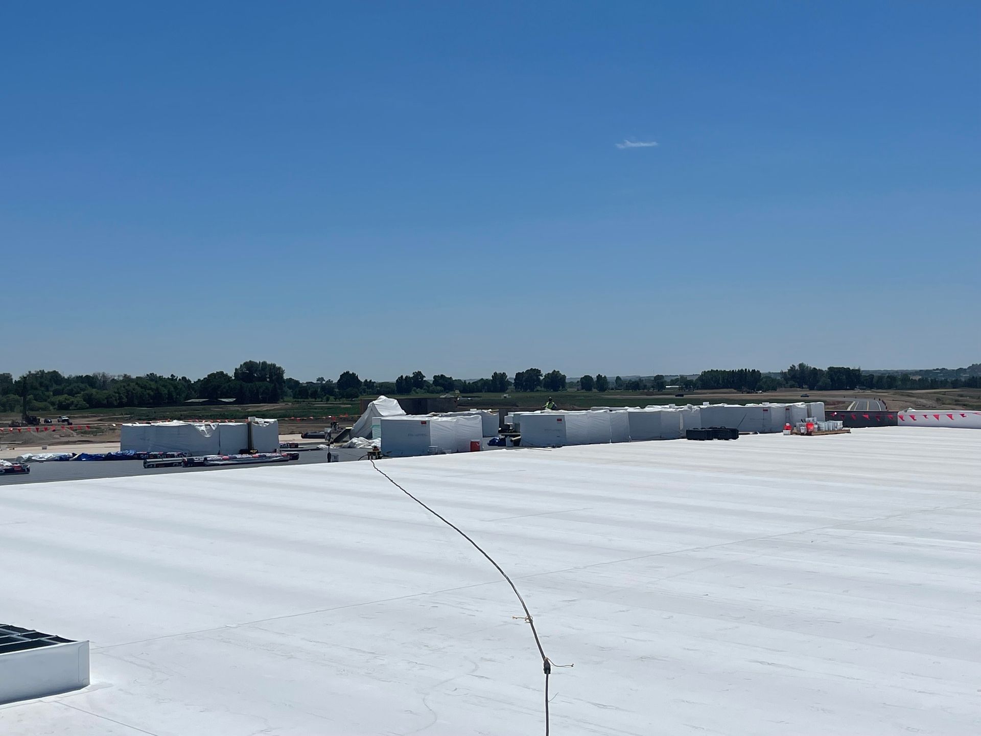 A large white roof with a blue sky in the background