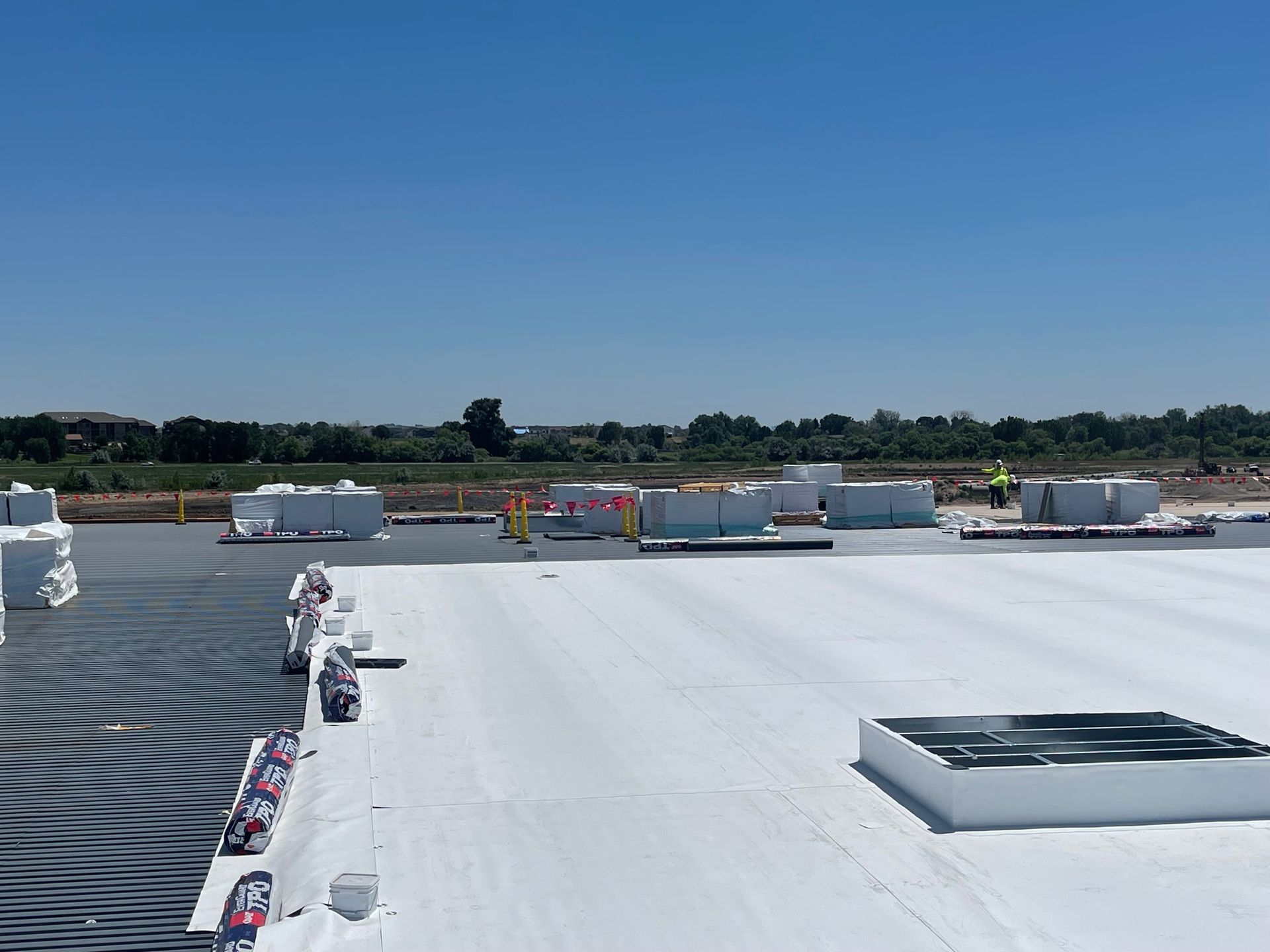 A large white roof with a blue sky in the background.