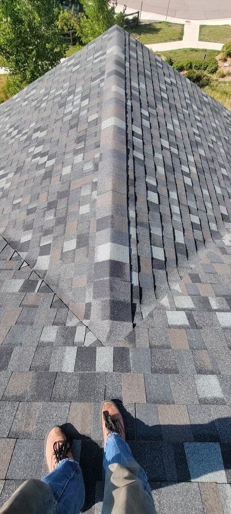 A person is standing on the roof of a house.