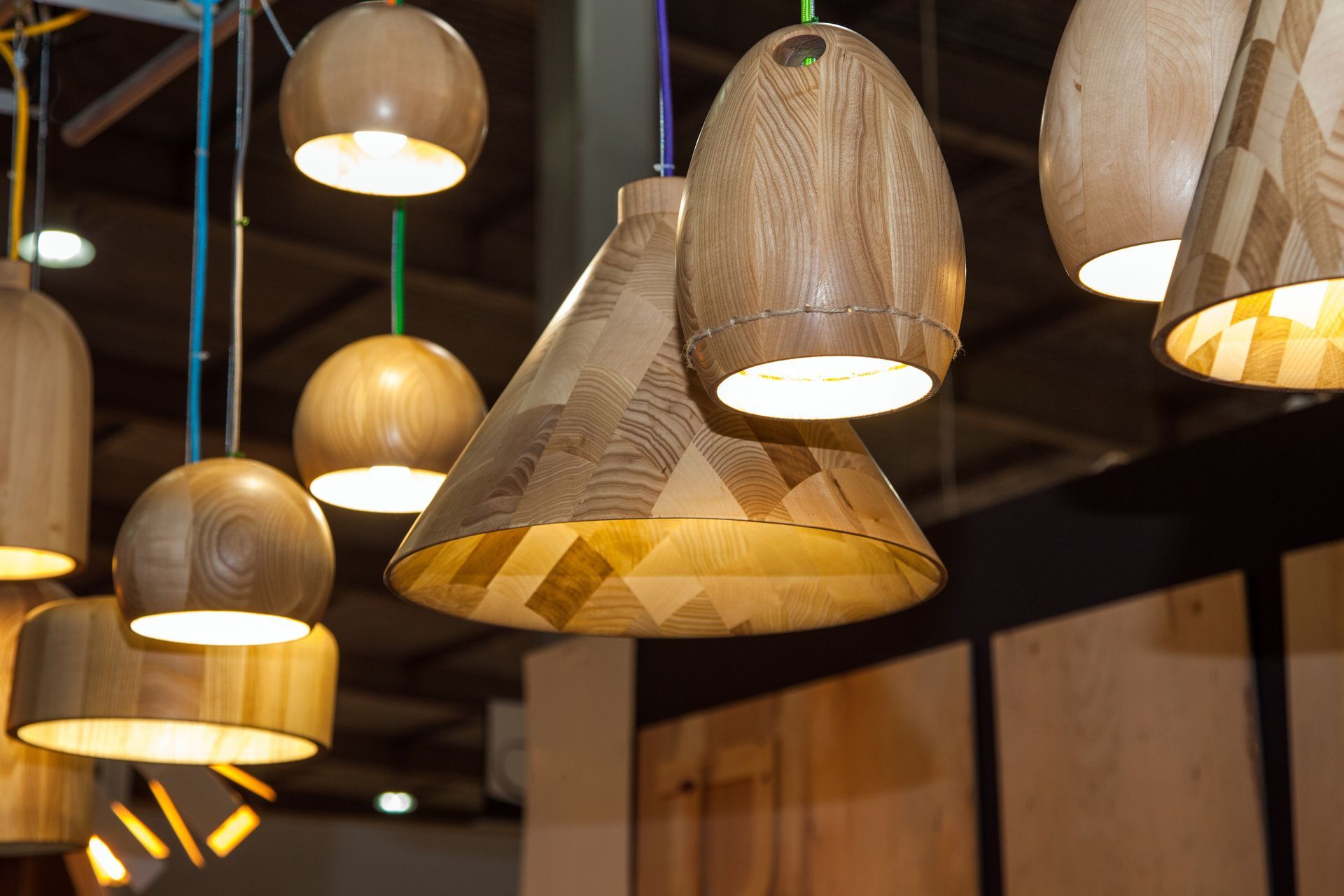 An array of sleek, wooden modern ceiling light fixtures suspended from the ceiling, casting a warm and inviting glow.