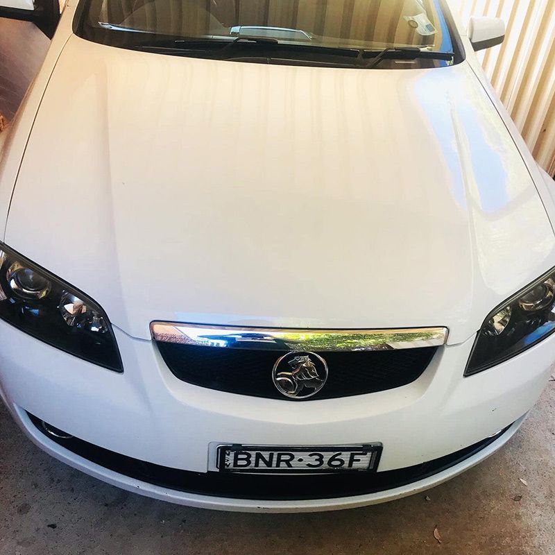 A White Car With a License Plate — Shine Your Ride In Karabar, NSW