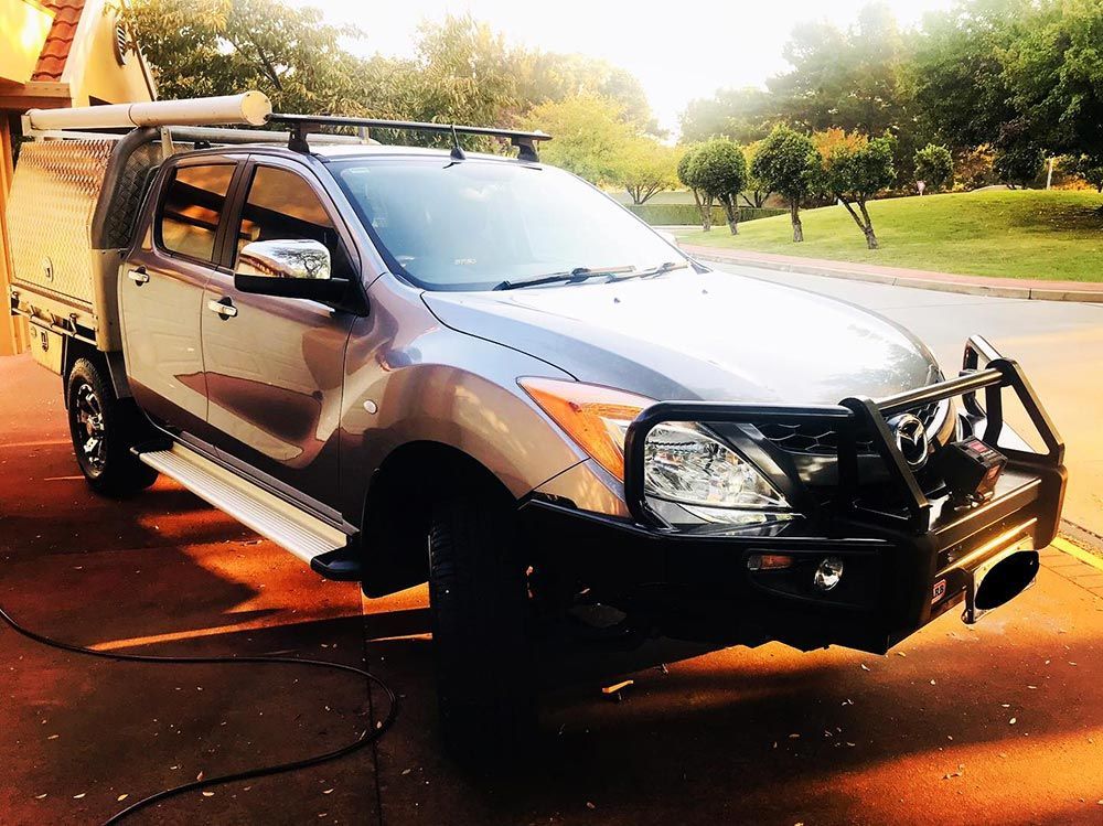 a Truck With a Canopy on Top of It is Parked on the Side of the Road — Shine Your Ride In Karabar, NSW