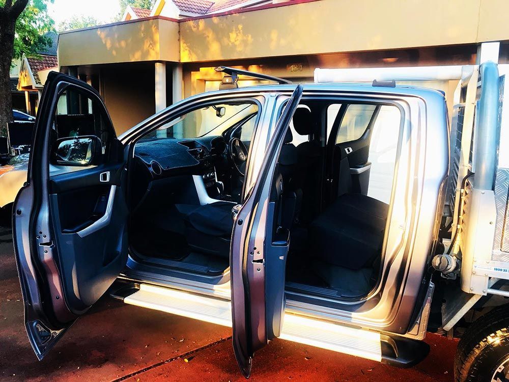 A Truck With Its Doors Open is Parked in Front of a House — Shine Your Ride In Karabar, NSW