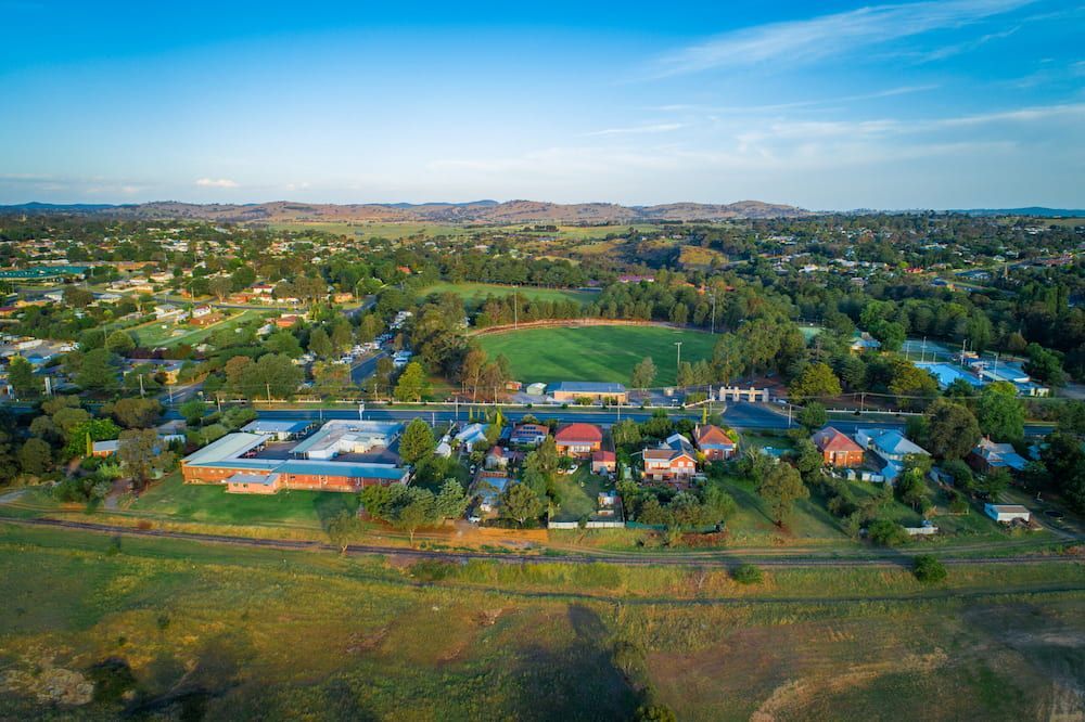 An Aerial View Of A Small Town With A Field In The Middle Of It — Shine Your Ride In Yass, NSW