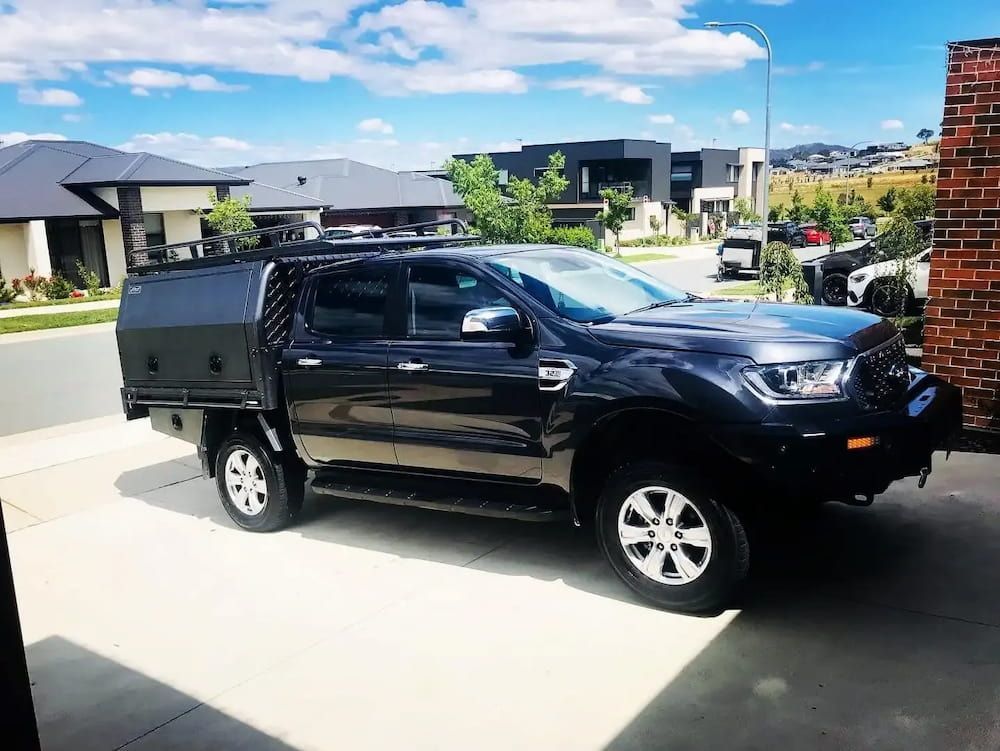 A Black Truck Parked In Front Of A Residential House — Shine Your Ride In Googong, NSW