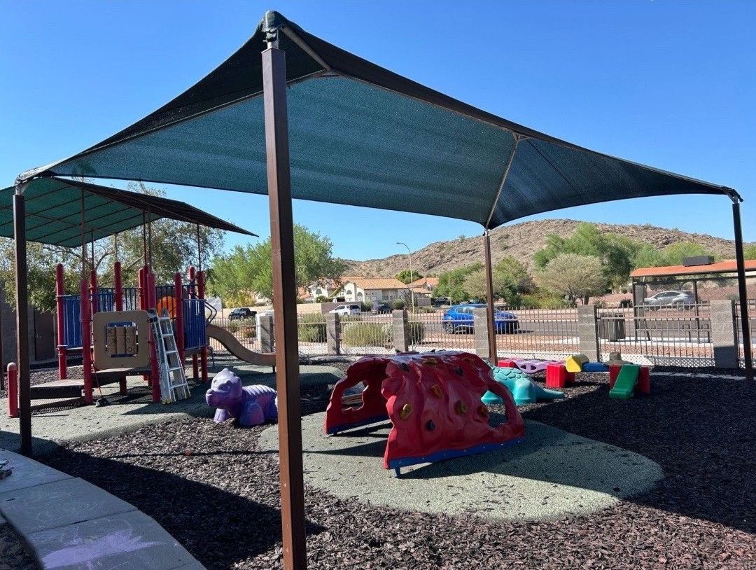 A playground with a canopy over it and a table