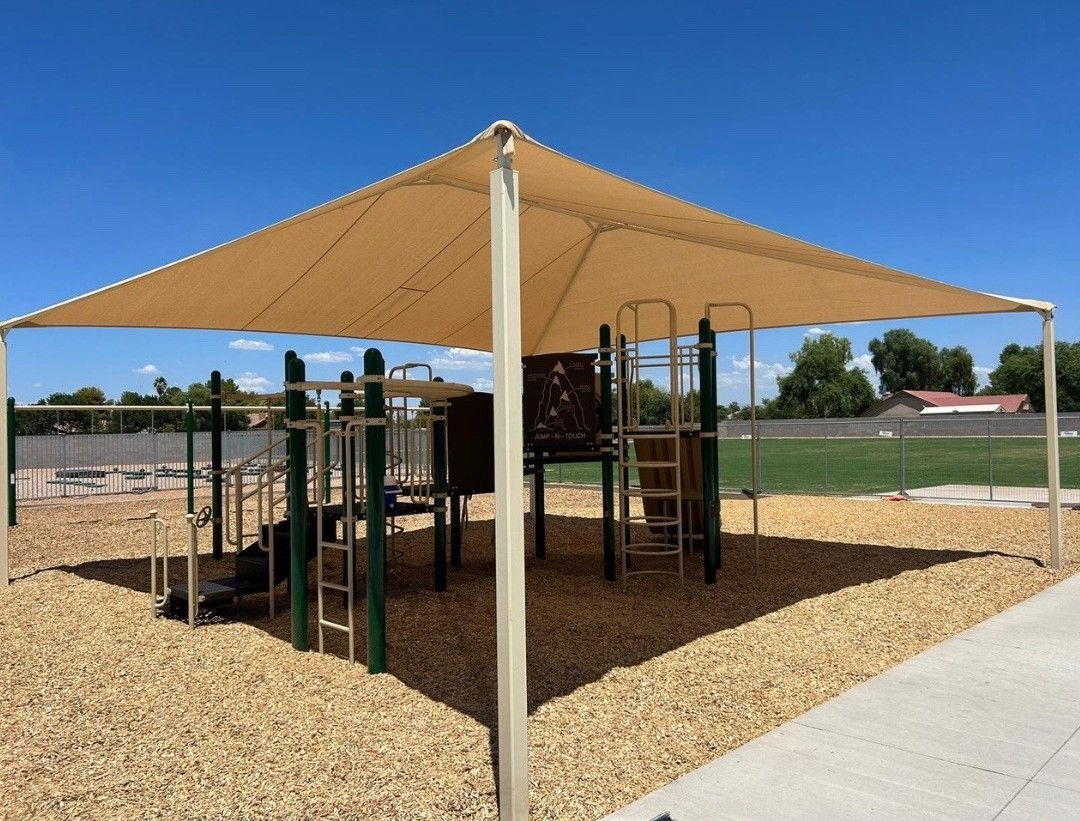 A playground with a large canopy over it