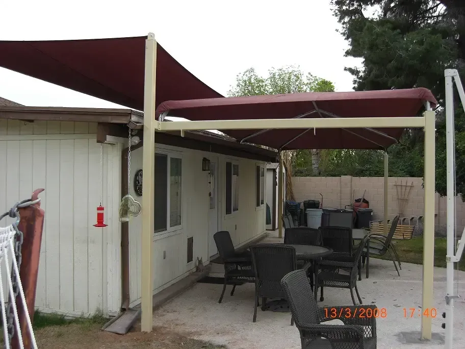 A patio with a table and chairs under an umbrella