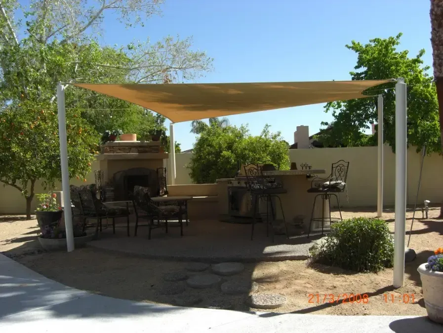 A patio with a canopy over it and a fireplace