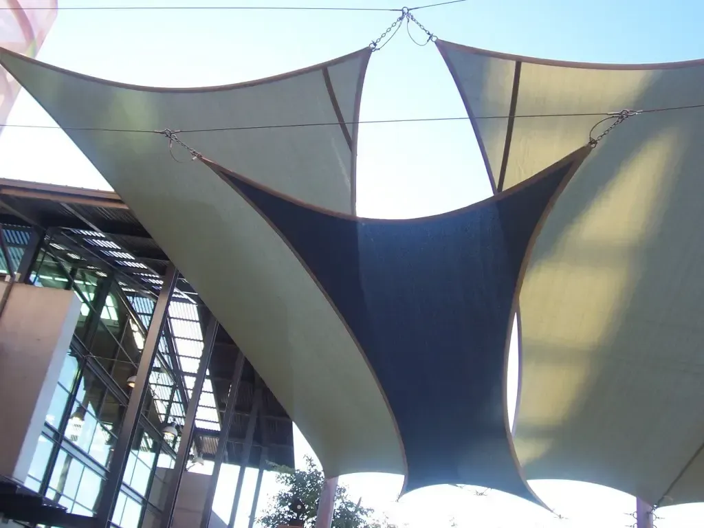 A large umbrella is hanging from the ceiling of a building