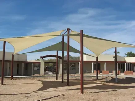 A large umbrella is sitting in front of a building
