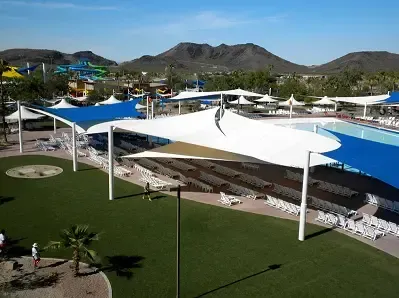 An aerial view of a water park with mountains in the background.