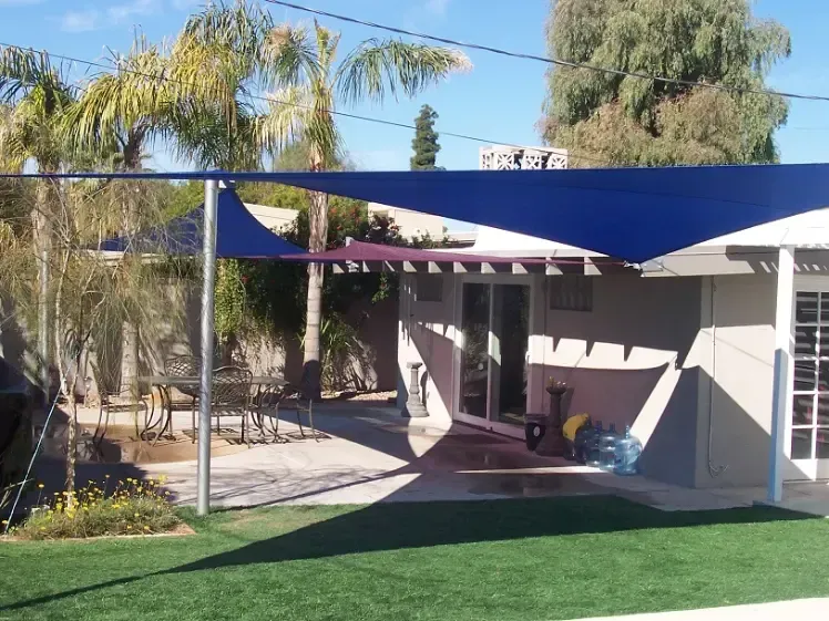 A house with a blue canopy over the backyard
