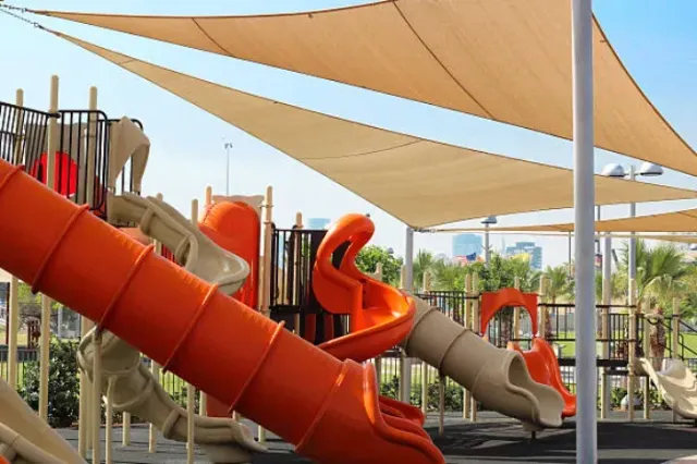 A playground with a lot of slides and shades