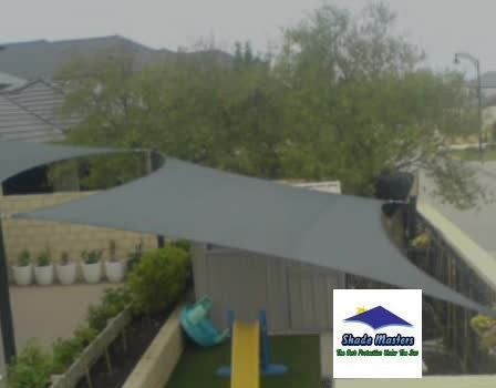 An aerial view of a playground with a shade sail covering it