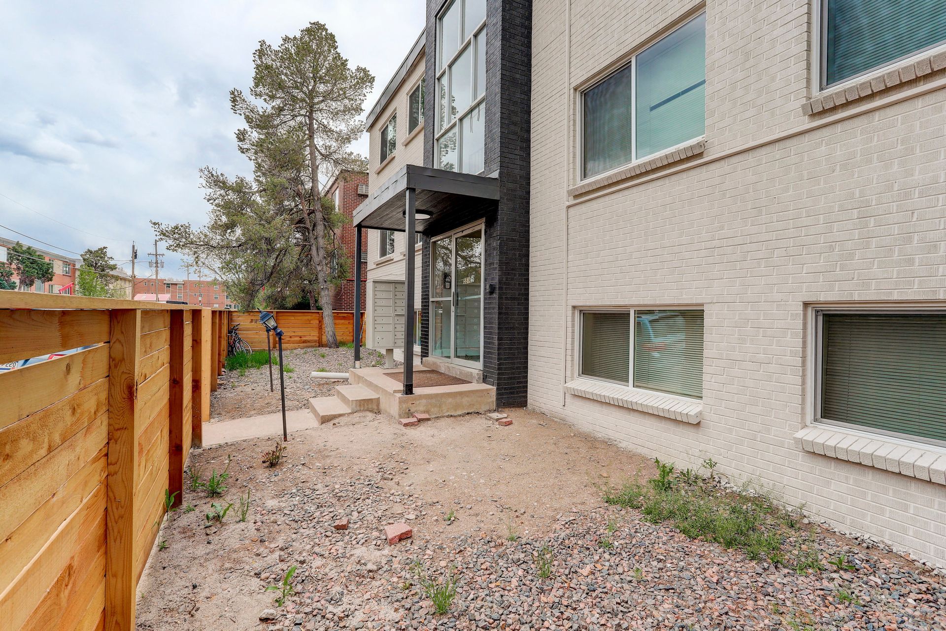 a large building with a wooden fence in front of it .