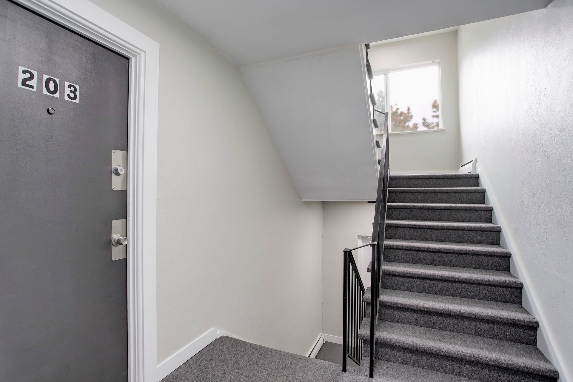 there is a staircase leading up to the second floor of a building .