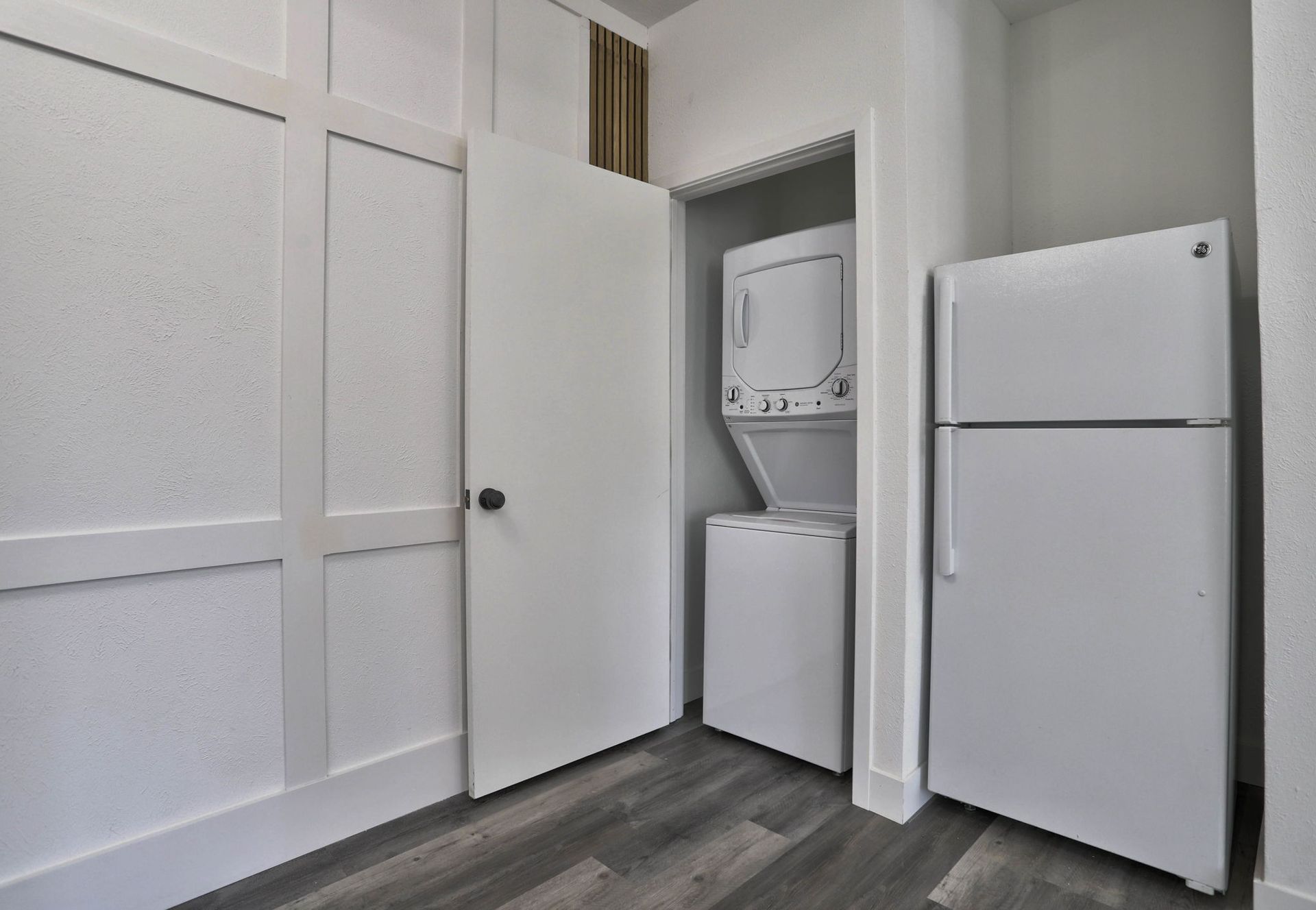 a laundry room with a washer and dryer and a refrigerator .
