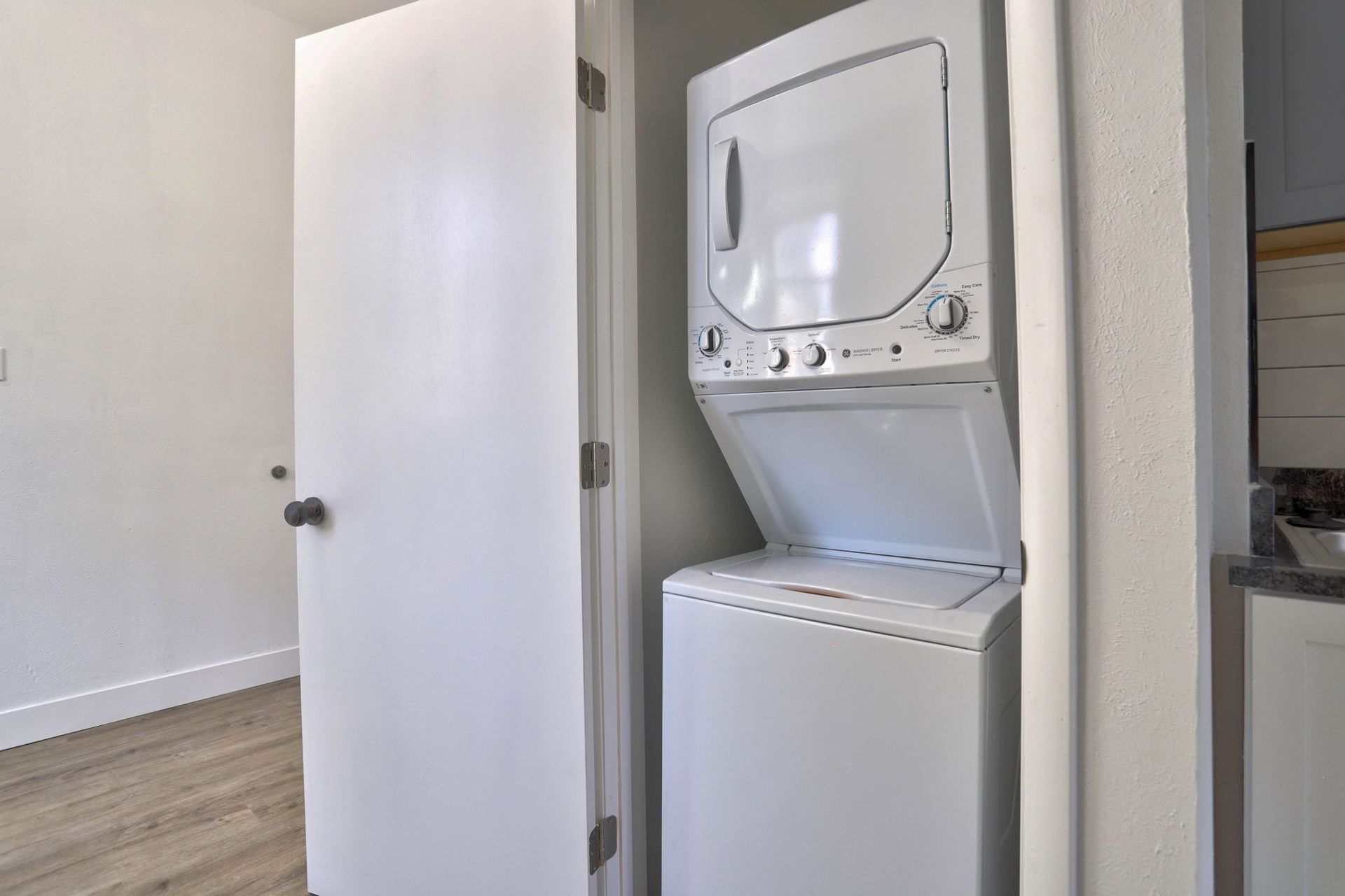 a washer and dryer are stacked on top of each other in a laundry room .